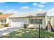 Charming single-story home with a well-maintained lawn, white tile roof and attached garage in a sunny neighborhood at 259 Mariposa, Winter Haven, FL 33884