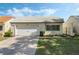 Charming single-story home featuring a well-maintained lawn and a one-car garage at 259 Mariposa, Winter Haven, FL 33884