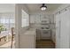 Bright kitchen with white cabinets and appliances, and a passthrough looking into the dining room at 259 Mariposa, Winter Haven, FL 33884