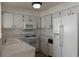 Bright kitchen with white appliances and cabinets, a gas range and spacious countertop at 259 Mariposa, Winter Haven, FL 33884
