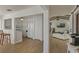Open-concept kitchen and living room with wood floors, a kitchen bar, and vaulted ceilings with exposed beams at 259 Mariposa, Winter Haven, FL 33884