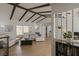 Bright open-concept living room with white walls, vaulted ceilings with wooden beams, and modern furnishings at 259 Mariposa, Winter Haven, FL 33884