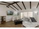 Bright living room features vaulted ceilings with dark wood beams, modern furniture, and hardwood floors at 259 Mariposa, Winter Haven, FL 33884