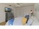 A main bedroom featuring a TV, ensuite bath, ceiling fan, and double closets at 259 Mariposa, Winter Haven, FL 33884