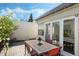 This brick-paved patio features a dining table and surrounding foliage for backyard enjoyment at 259 Mariposa, Winter Haven, FL 33884