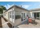 This charming outdoor patio is brick-paved and features a dining table and chairs set beneath a bright sky at 259 Mariposa, Winter Haven, FL 33884