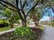 Scenic street view showing lush landscaping and mature trees lining the road in the community at 259 Mariposa, Winter Haven, FL 33884
