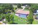 Aerial view of home with pool and fenced pool area surrounded by mature trees at 2611 State Road 557, Lake Alfred, FL 33850