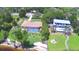 Aerial view of neighboring single Gathering homes with pools and green lawns at 2611 State Road 557, Lake Alfred, FL 33850