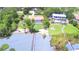 Stunning aerial view of waterfront homes with lush landscaping, private docks, and sparkling pools at 2611 State Road 557, Lake Alfred, FL 33850