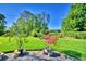 Well maintained lawn in the backyard includes potted decorative trees and patio at 2611 State Road 557, Lake Alfred, FL 33850