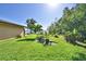 Expansive backyard with lush green grass, landscaping, and views of the lake at 2611 State Road 557, Lake Alfred, FL 33850