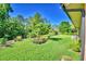 Landscaping and green grass cover the backyard of this home at 2611 State Road 557, Lake Alfred, FL 33850