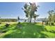 Waterfront backyard featuring a grassy lawn and access to the lake with pier at 2611 State Road 557, Lake Alfred, FL 33850