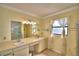 Bright bathroom with a double vanity, ample counter space, and a glass-enclosed shower at 2611 State Road 557, Lake Alfred, FL 33850