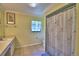 The updated bathroom features tile flooring, framed mirror, and shower with curtain at 2611 State Road 557, Lake Alfred, FL 33850