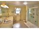 Bright bathroom with dual sinks, large mirror, and glass-enclosed shower at 2611 State Road 557, Lake Alfred, FL 33850