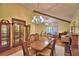Traditional dining room with chandelier, cabinets, and wooden table set at 2611 State Road 557, Lake Alfred, FL 33850