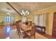 Formal dining room with large table, chandelier, and natural light at 2611 State Road 557, Lake Alfred, FL 33850
