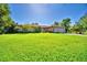 Well-kept lawn with home, large trees, and two-car garage at 2611 State Road 557, Lake Alfred, FL 33850