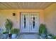 Front double doors accented by potted plants and a stone skirt give this home great curb appeal at 2611 State Road 557, Lake Alfred, FL 33850