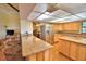 Well-appointed kitchen with granite countertops, stainless steel appliances, and breakfast bar at 2611 State Road 557, Lake Alfred, FL 33850