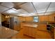 Spacious kitchen with light wood cabinets, granite countertops, and stainless steel appliances at 2611 State Road 557, Lake Alfred, FL 33850
