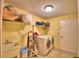Functional laundry room featuring modern washer and dryer, sink and storage at 2611 State Road 557, Lake Alfred, FL 33850