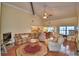 Living room with vaulted ceilings, wood flooring and view of the kitchen and dining room at 2611 State Road 557, Lake Alfred, FL 33850