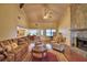 Spacious living room with vaulted ceilings, fireplace, and open floor plan to kitchen area at 2611 State Road 557, Lake Alfred, FL 33850