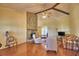Inviting living room with a stone fireplace and vaulted ceilings with exposed beams at 2611 State Road 557, Lake Alfred, FL 33850