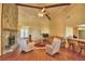 Comfortable living room featuring a stone fireplace, vaulted ceiling and plenty of seating at 2611 State Road 557, Lake Alfred, FL 33850