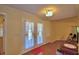 Living room with French doors and wood flooring, accented by a bright red throw rug at 2611 State Road 557, Lake Alfred, FL 33850