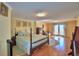 Bright main bedroom featuring a four poster bed and private balcony at 2611 State Road 557, Lake Alfred, FL 33850