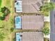 Birds eye view of the rear of homes with private, screened-in pools at 2721 Kokomo Loop, Haines City, FL 33844
