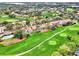 Aerial view of the community's lush golf course and well-maintained homes at 2721 Kokomo Loop, Haines City, FL 33844