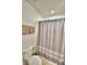 Functional bathroom with a toilet, shower with curtain, and towel rack at 2721 Kokomo Loop, Haines City, FL 33844
