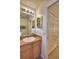 Bathroom with vanity, sink, and mirror, next to closet with folding doors at 2721 Kokomo Loop, Haines City, FL 33844