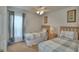 Bright bedroom featuring two twin beds with gray plaid bedding, a lamp, and window at 2721 Kokomo Loop, Haines City, FL 33844