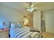 Bedroom featuring a queen bed with striped bedding, ceiling fan, and lamps at 2721 Kokomo Loop, Haines City, FL 33844