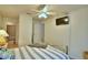 Cozy bedroom featuring a ceiling fan, TV, and en-suite bathroom at 2721 Kokomo Loop, Haines City, FL 33844