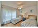 Bright bedroom featuring two twin beds with striped bedding and natural light at 2721 Kokomo Loop, Haines City, FL 33844