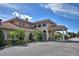 Elegant clubhouse entrance with well-maintained landscaping, offering a sophisticated welcome at 2721 Kokomo Loop, Haines City, FL 33844