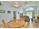 Sunlit dining area with vaulted ceilings and a view of the outdoor living space and pool at 2721 Kokomo Loop, Haines City, FL 33844