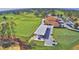 Scenic view of golf course with a driving range, lush greenery, and covered seating area for relaxing at 2721 Kokomo Loop, Haines City, FL 33844