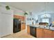 Spacious kitchen with adjacent dining area, black refrigerator, and tile flooring at 2721 Kokomo Loop, Haines City, FL 33844