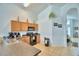 Cozy kitchen featuring wood cabinets, black appliances, and tiled floors at 2721 Kokomo Loop, Haines City, FL 33844