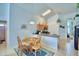 A kitchen area with a dining table next to a hallway and a bathroom at 2721 Kokomo Loop, Haines City, FL 33844