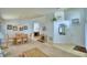 A spacious living room with an adjacent dining area, neutral decor, and tile entry at 2721 Kokomo Loop, Haines City, FL 33844
