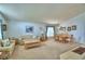 Bright living room featuring a dining area, neutral carpet, and comfortable furnishings at 2721 Kokomo Loop, Haines City, FL 33844